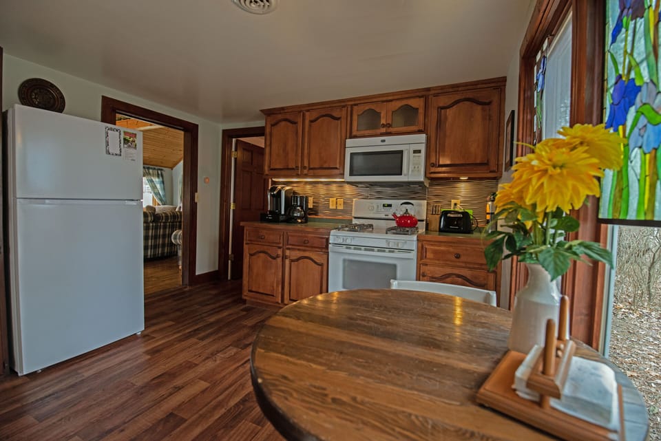 Kitchen with oven, keurig, stocked with dishes and silverware, and more