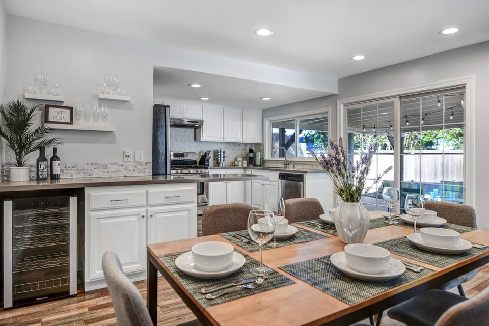 Dining room has table for 6 and includes a wine fridge.