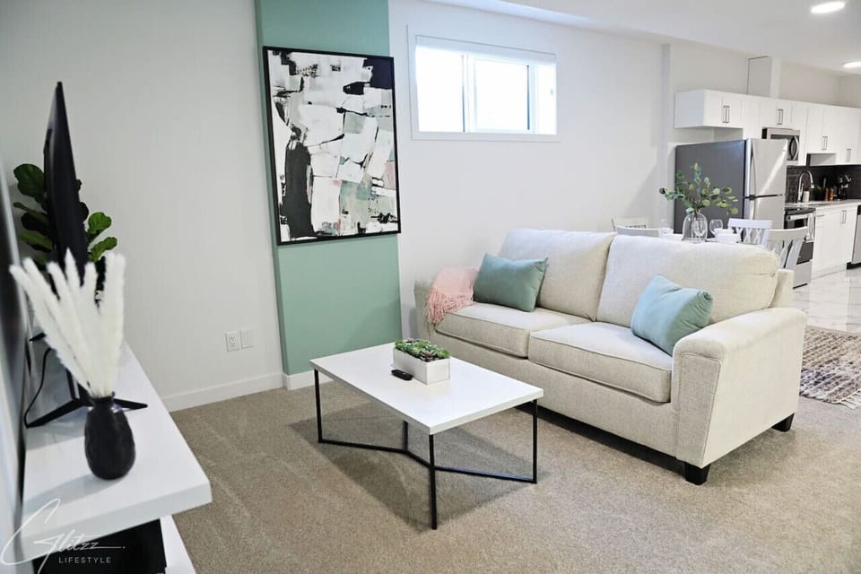 Bringing brightness to a basement, this modern living room is a chic and inviting space.