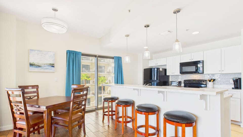 Full kitchen with island + breakfast bar and dining area with seating for 8