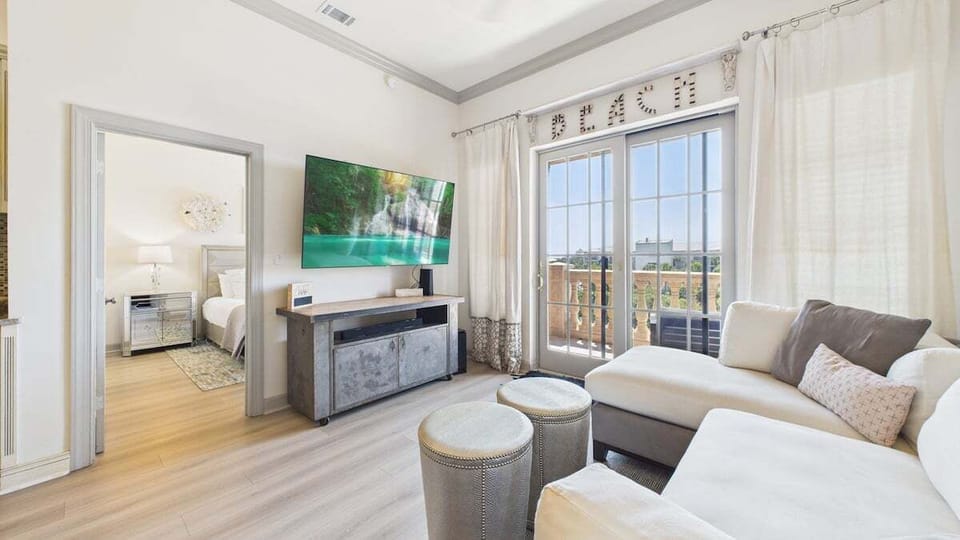 The living area is equipped with ample seating and a huge TV