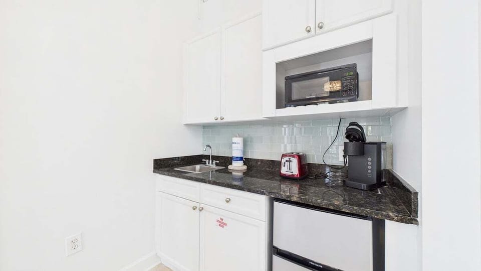 Kitchenette equipped with microwave mini fridge and coffee maker