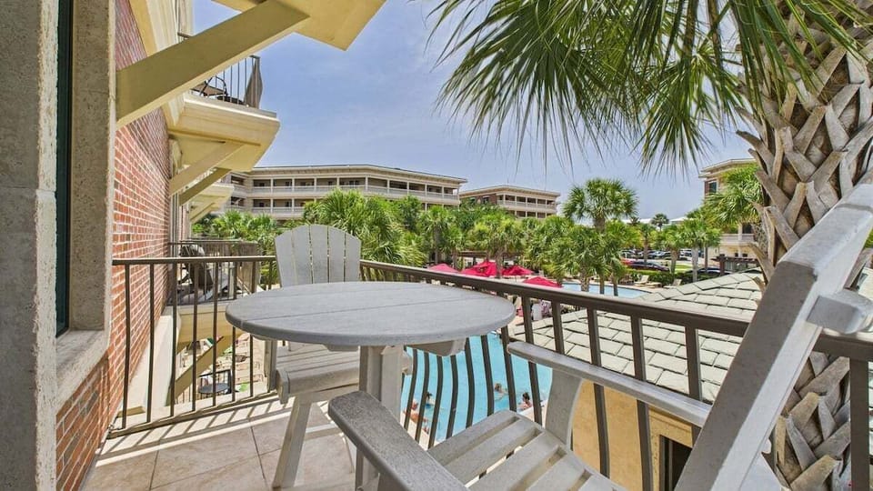 Balcony with table and seats overlooking resort amenities
