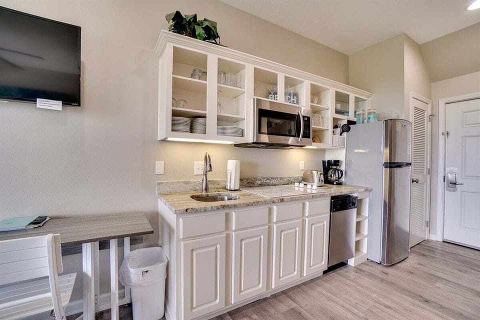 Kitchenette with cook top, fridge and microwave.