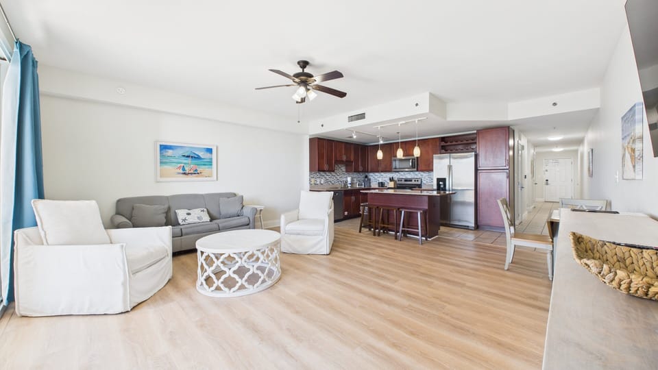 Open concept living area with stylish furnishings and gulf views + TV