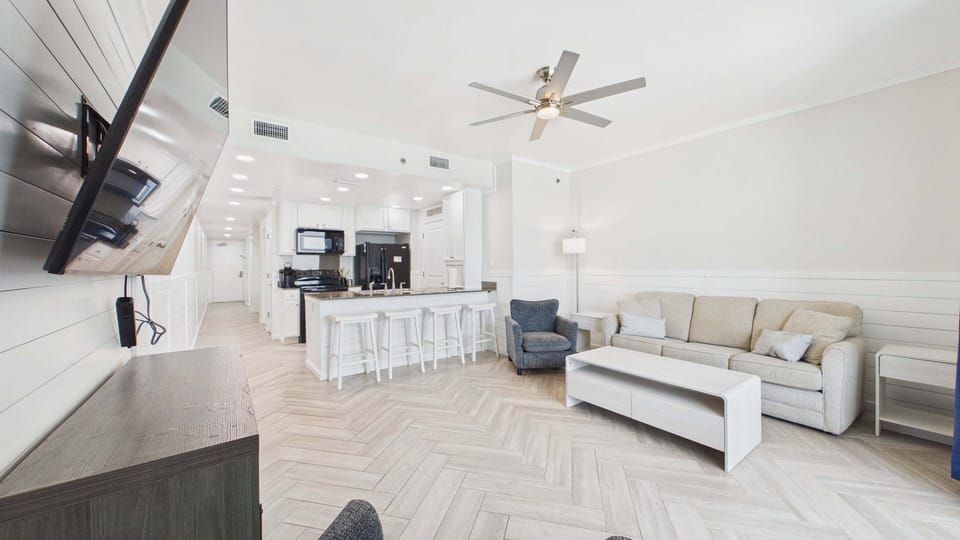 Open concept living area with huge TV and comfy furnishings + sleeper sofa (sleeps 2)