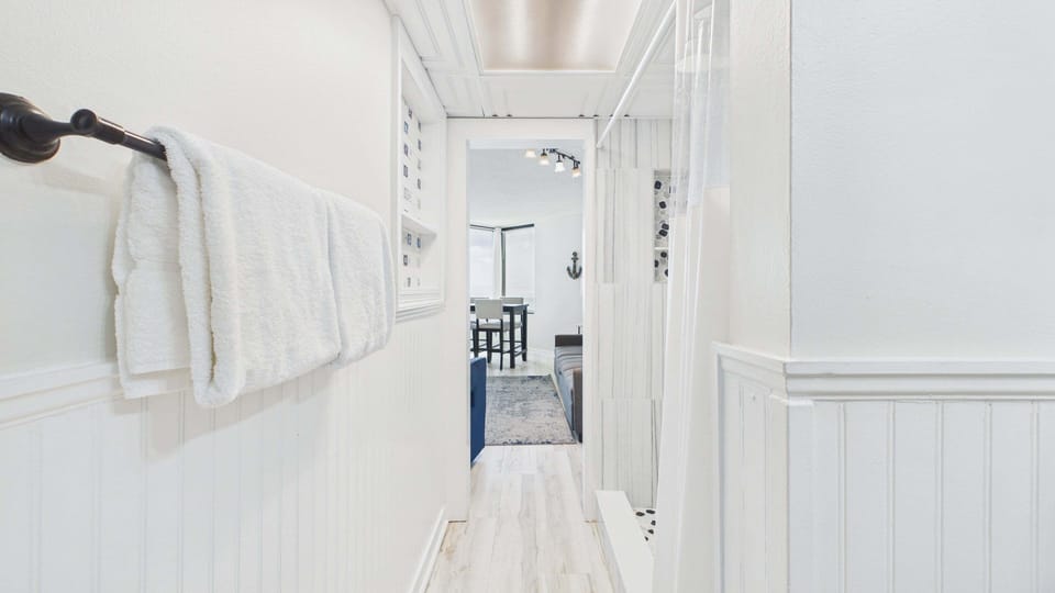 Full bathroom shared with living area includes shower and tub combo