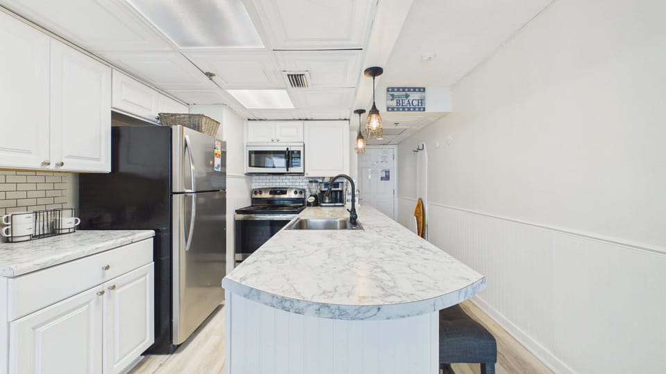 Full fridge and modern appliances throughout kitchen