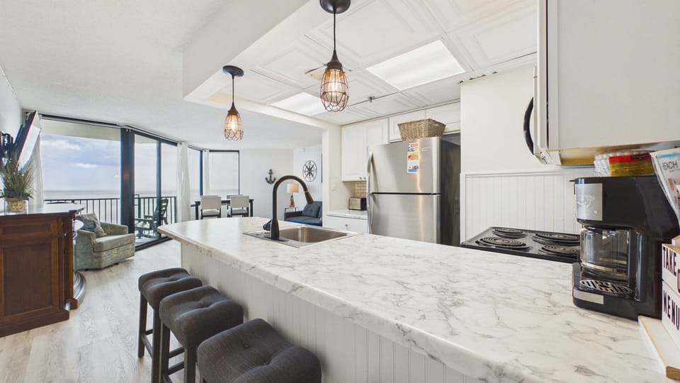 Fully applianced kitchen with all the cooking essentials. Breakfast bar seating additionally on counter.