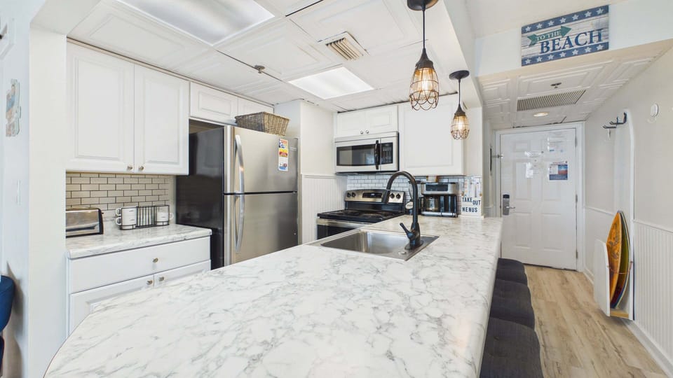 Fully applianced kitchen with all the cooking essentials. Breakfast bar seating additionally on counter.