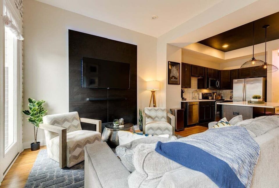 Open concept living area with stylish furnishings and ample seating with balcony access