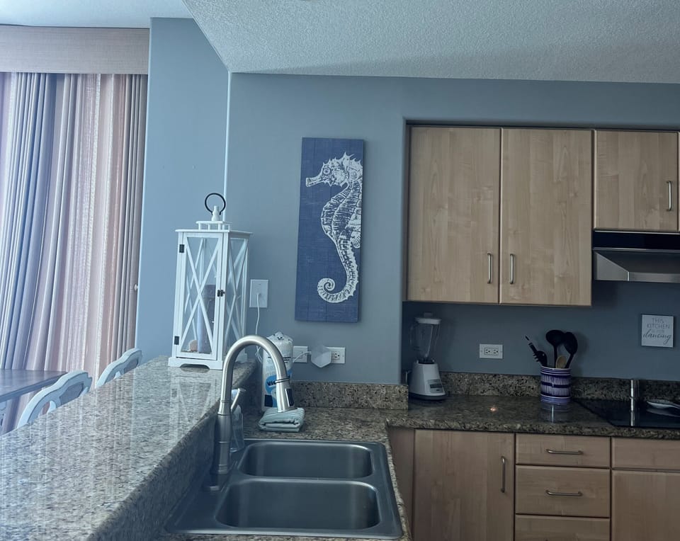Fully stocked kitchen with stainless appliances.

