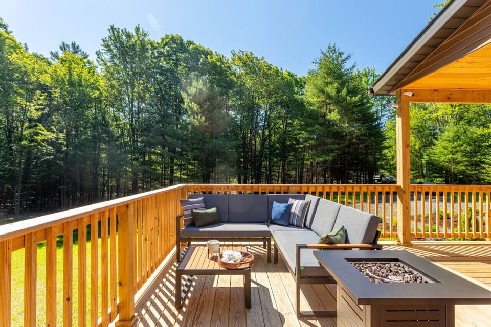 Deck with lounge sofa seating and propane fire table