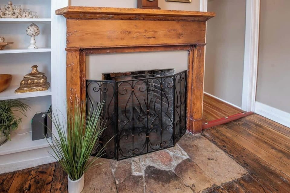 Indulge in the nostalgia of yesteryears in our inviting Airbnb, where an original hearth and gleaming hardwood floors take center stage.