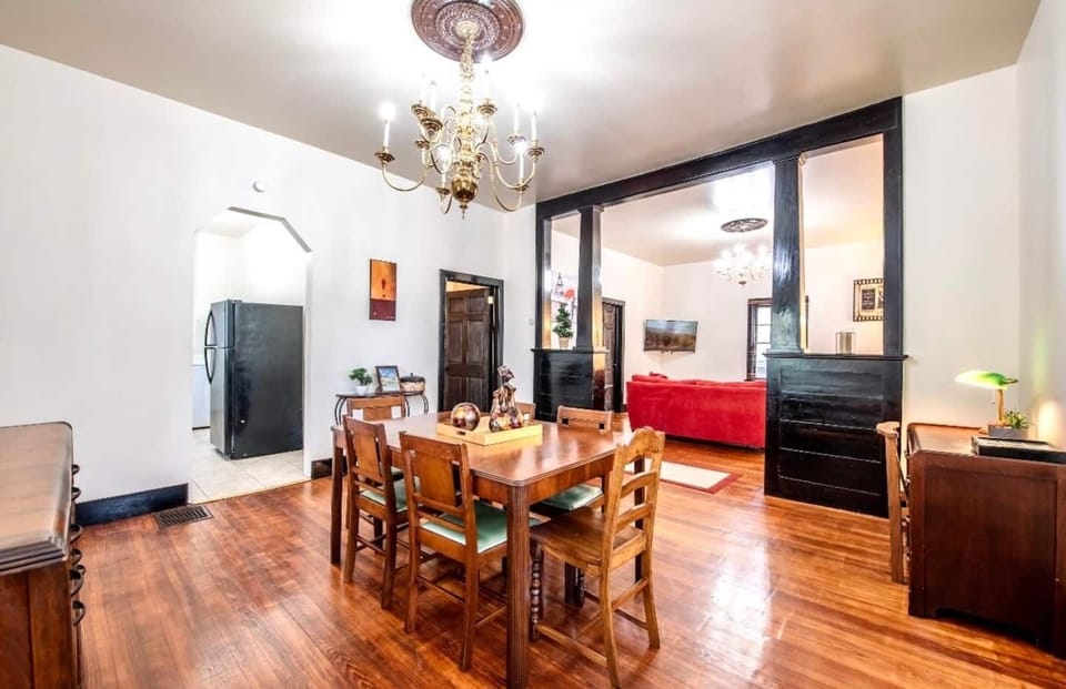 Enjoy intimate meals or lively dinner parties in this enchanting dining area. (The red couch has been replaced)