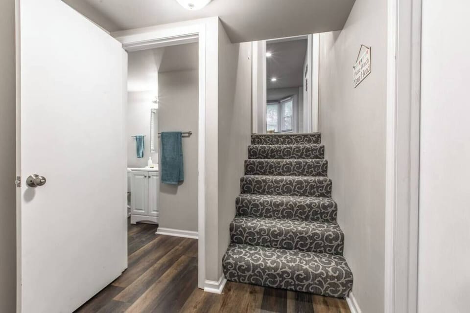 Stay connected to the heart of the home with our bathroom near the stairs.
