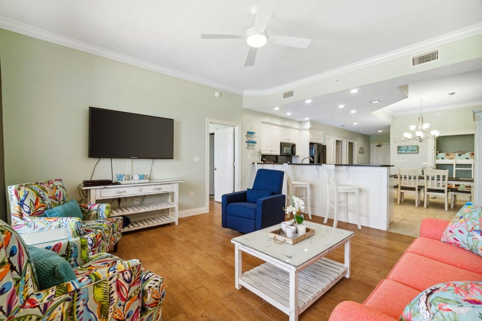 Spacious living room w/ large TV, ceiling fan & easy flow for lounging w/ the whole crew.