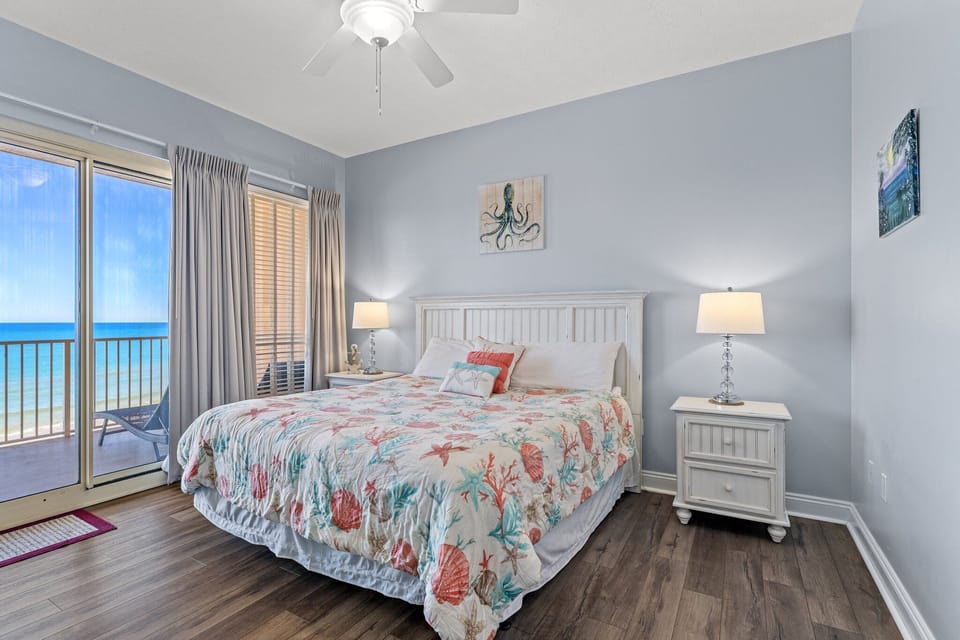 Relax in this coastal-themed bedroom with ocean views and natural light.