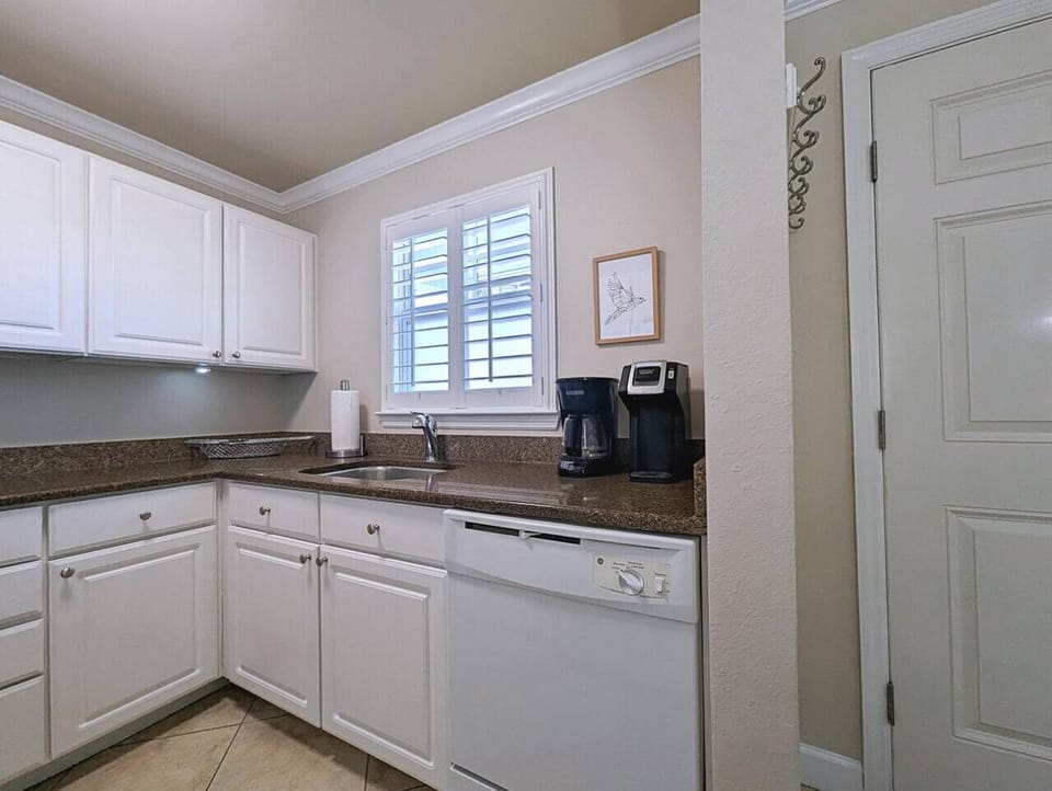Clean white kitchen w/ ample counters & natural light for everyday cookingClean white kitchen w/ ample counters & natural light for everyday cooking