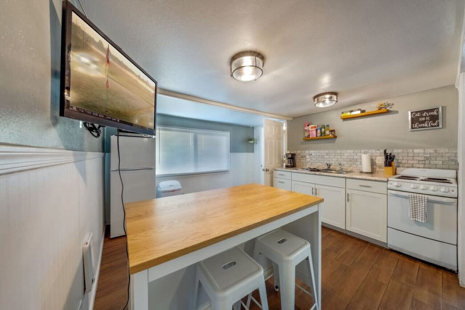 Kitchen with island/seating area with seating for two, and smart TV