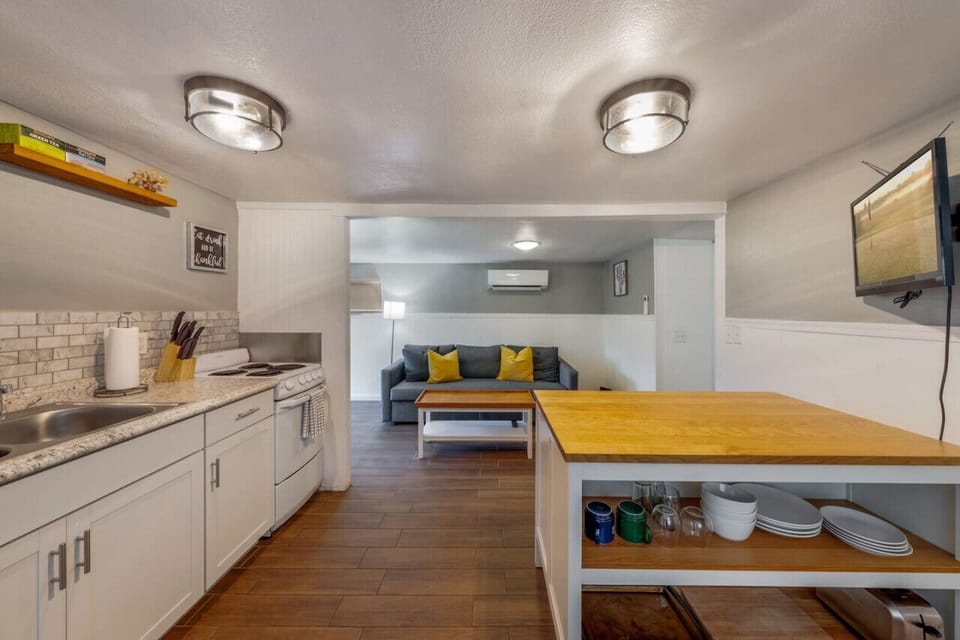 Kitchen with 4-burner electric stove, oven, and refrigerator