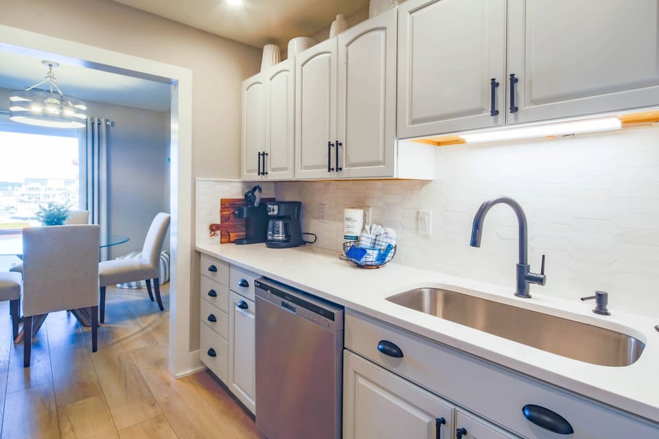 The galley kitchen leads to the dining area.