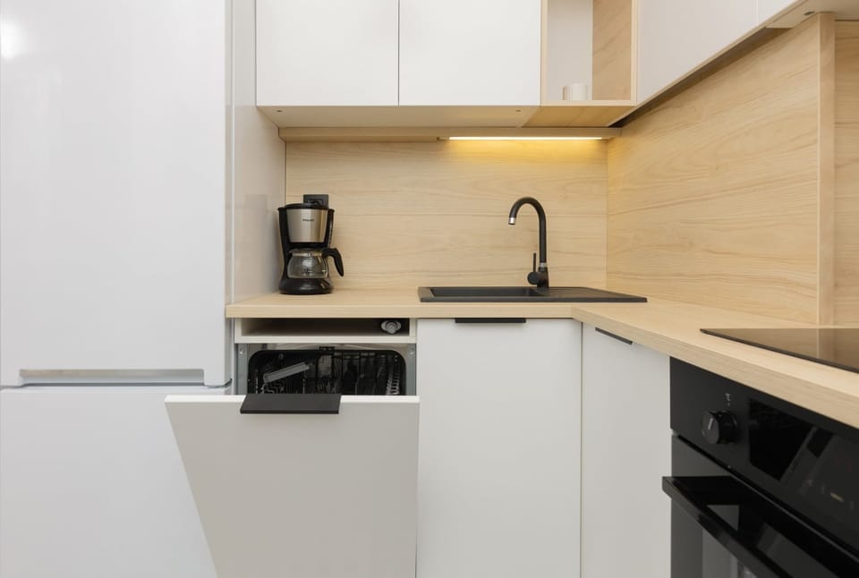 Kitchenette with oven and refrigerator. 