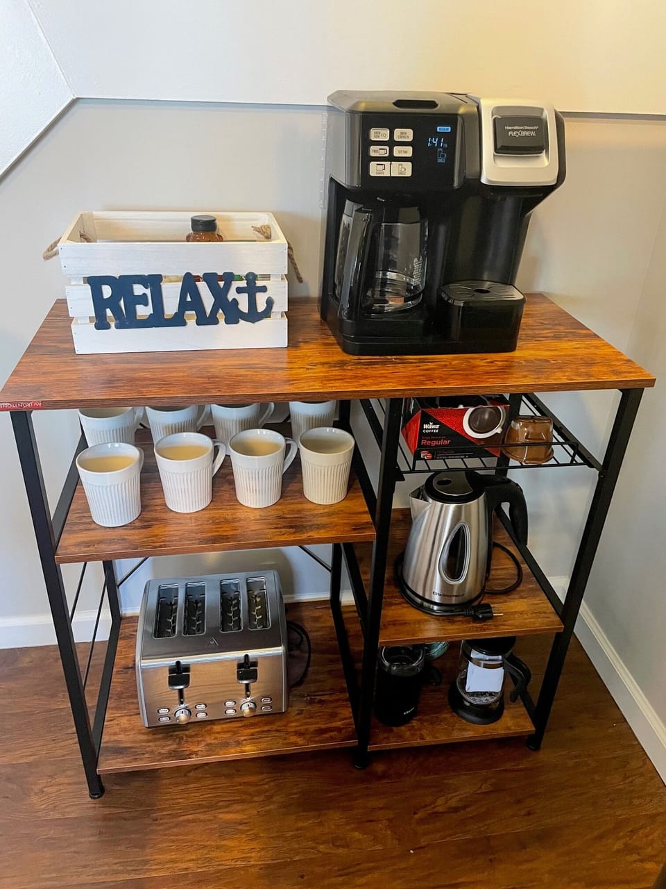 Coffee bar with duo coffee maker, electric kettle, French press and K-cups.