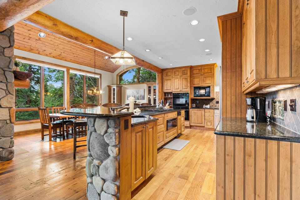 Your dream kitchen awaits with rich wood cabinetry, granite countertops, and stone accents where culinary adventures begin.