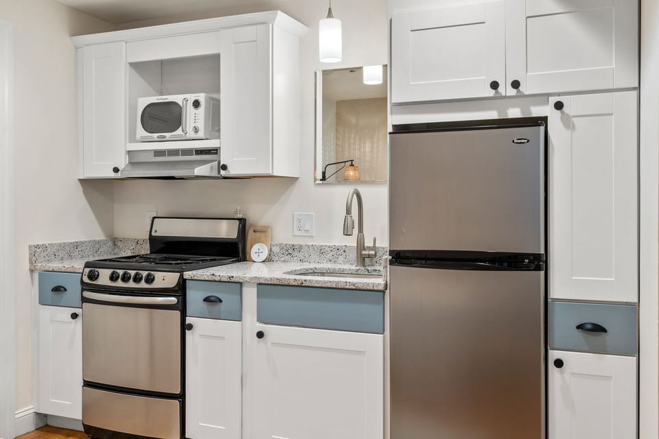 Kitchen with essentials. Glassware, utensils, baking sheets, cutting boards, and more. 