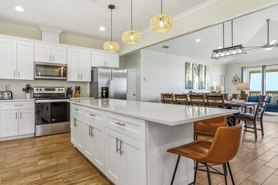 Your spacious kitchen boasts gleaming quartz countertops, stainless steel appliances, and a large island where you'll love cooking and gathering together.
