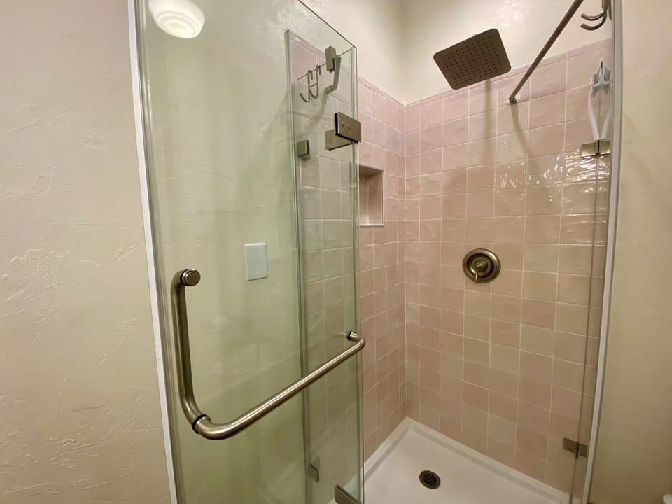 Spoonbill-inspired tiles in rainfall shower, refresh with wildlife vibes.