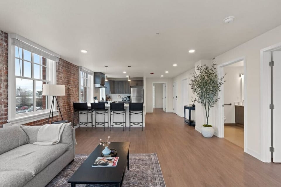Sunlit living space with large windows and an open-concept layout.