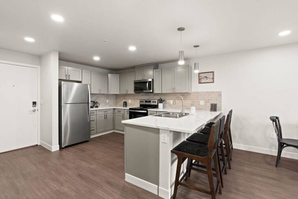 Bright, airy kitchen with designer lighting and plenty of counter space.