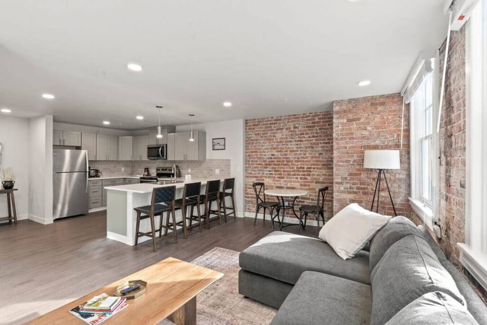 Sunlit living space with large windows and an open-concept layout.