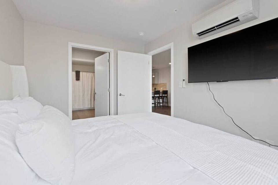 Spacious bedroom with thoughtful touches and ambient lighting.