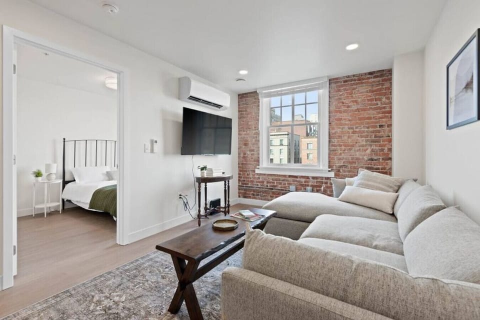 Sunlit living space with large windows and an open-concept layout.