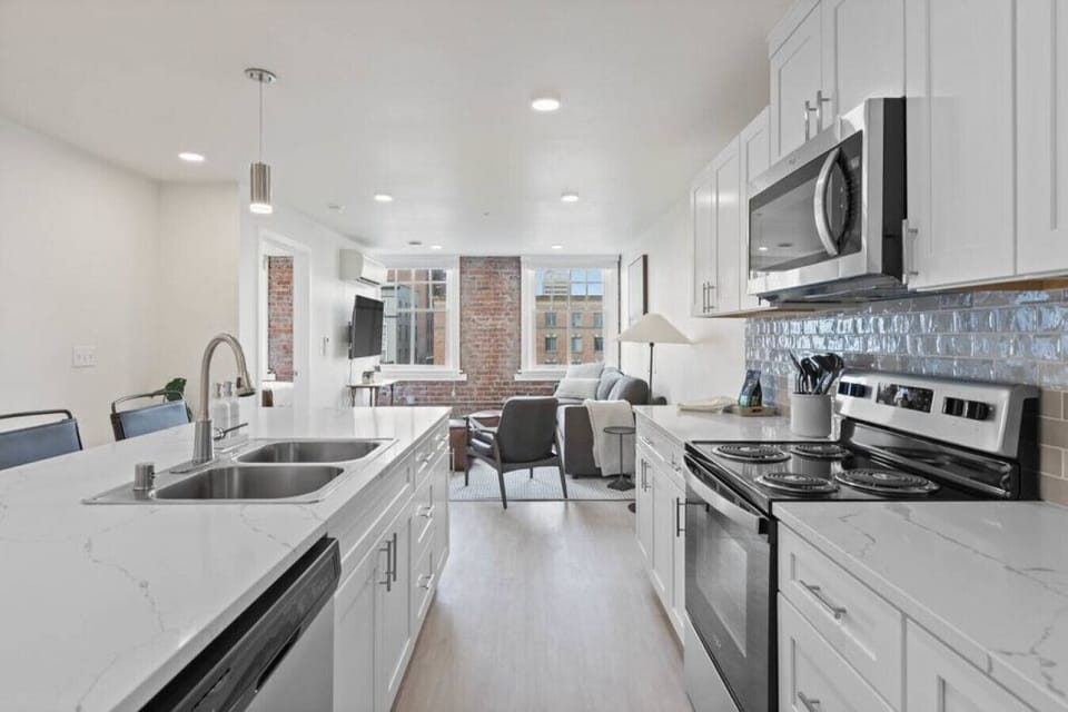 Sleek, fully stocked kitchen with high-end appliances—perfect for home-cooked meals or morning coffee.