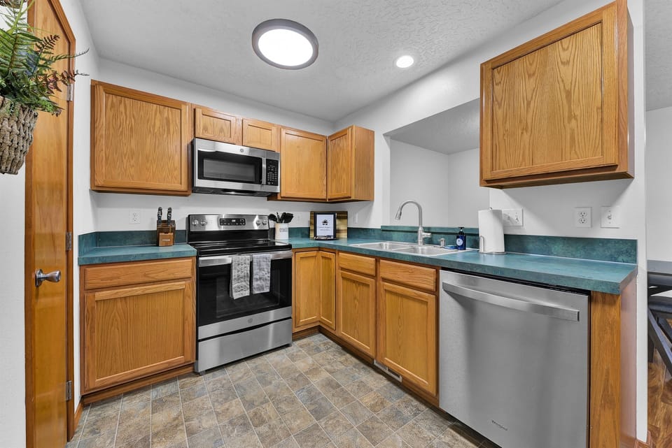 Kitchen with dishwasher, oven/range, microwave, and pantry