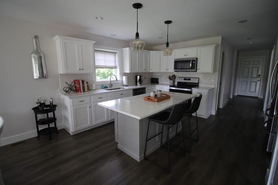 Clean modern kitchen fully equipped with cookware