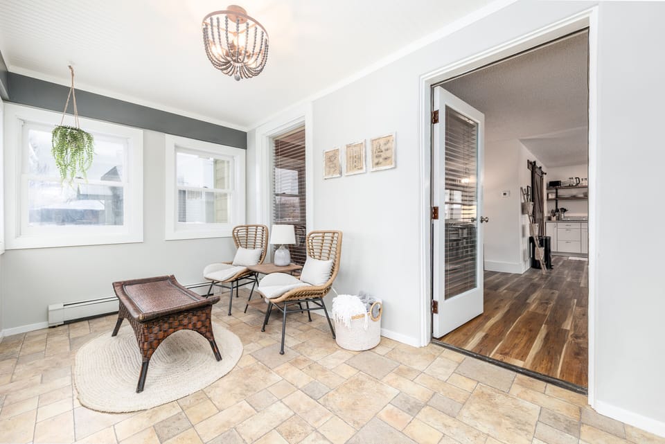 Enter through a comfortable enclosed porch