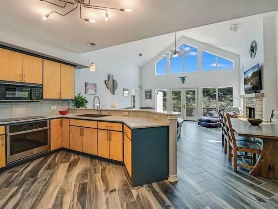 Full-size open kitchen with all appliances, cookware, plates, bowls, cups, etc. 