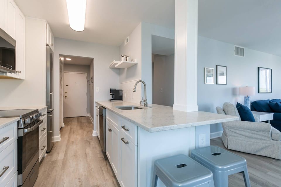 Adjacent to the living and dining rooms, the kitchen breakfast bar has seating for 2.