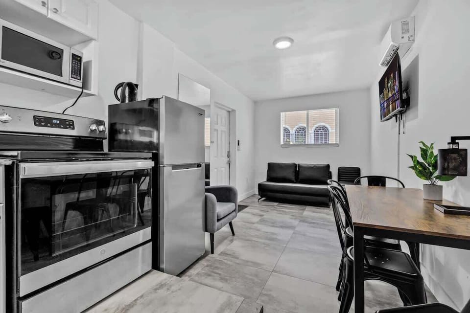 Whip up meals with ease in this sleek kitchen featuring granite counters, coffee maker, and microwave.

