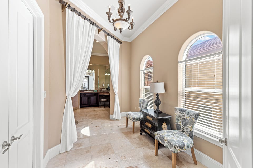 Luxuriate in your elegant en-suite retreat, where flowing curtains frame tranquil moments and natural light dances through arched windows.