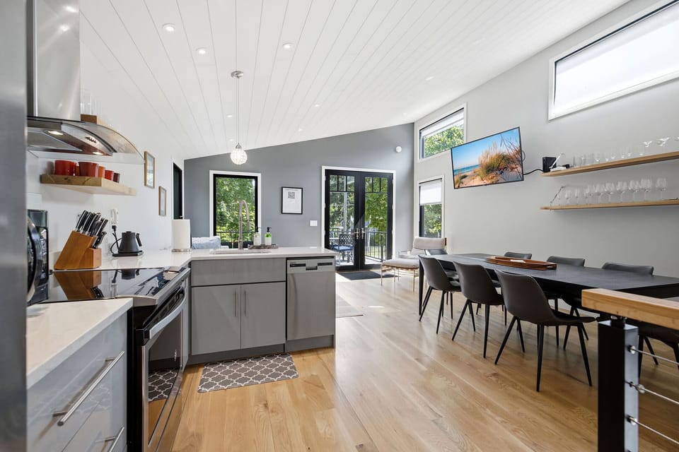 Kitchen, dining, and deck stay connected for easy indoor outdoor entertaining.