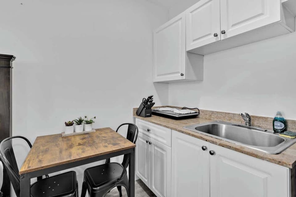 Gather around this stylish dining nook with rustic charm and all the essentials. Ideal for couples or solo guests looking for a functional Airbnb with a homey vibe.