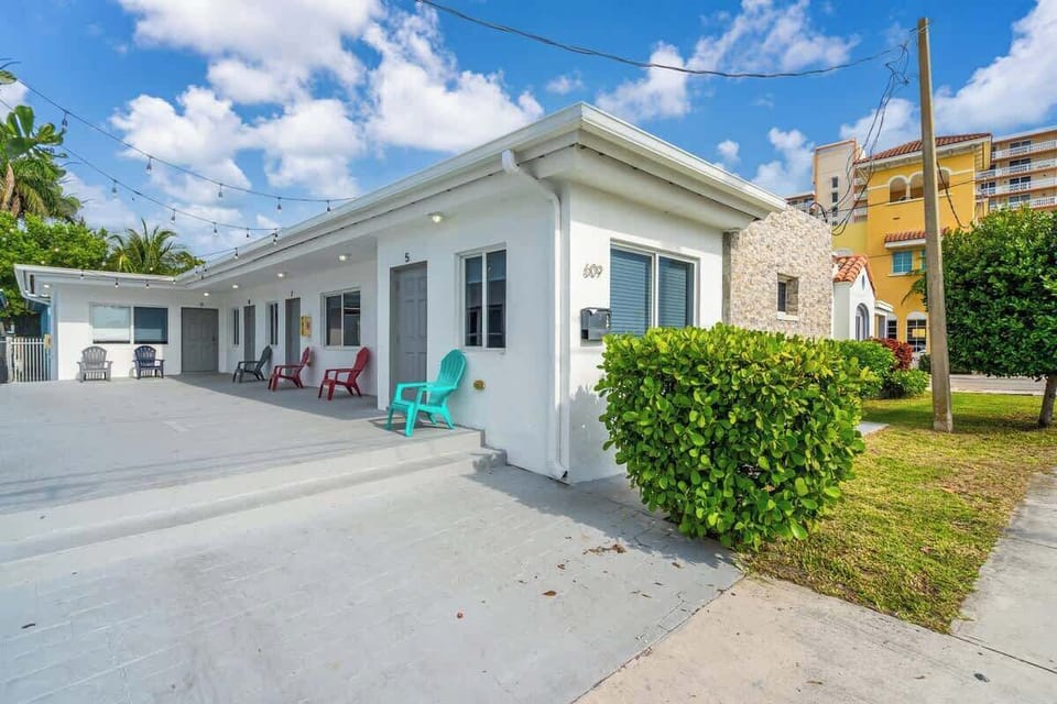 Colorful chairs, string lights, and a welcoming vibe—this charming vacation rental offers a laid-back outdoor space just minutes from the beach.

