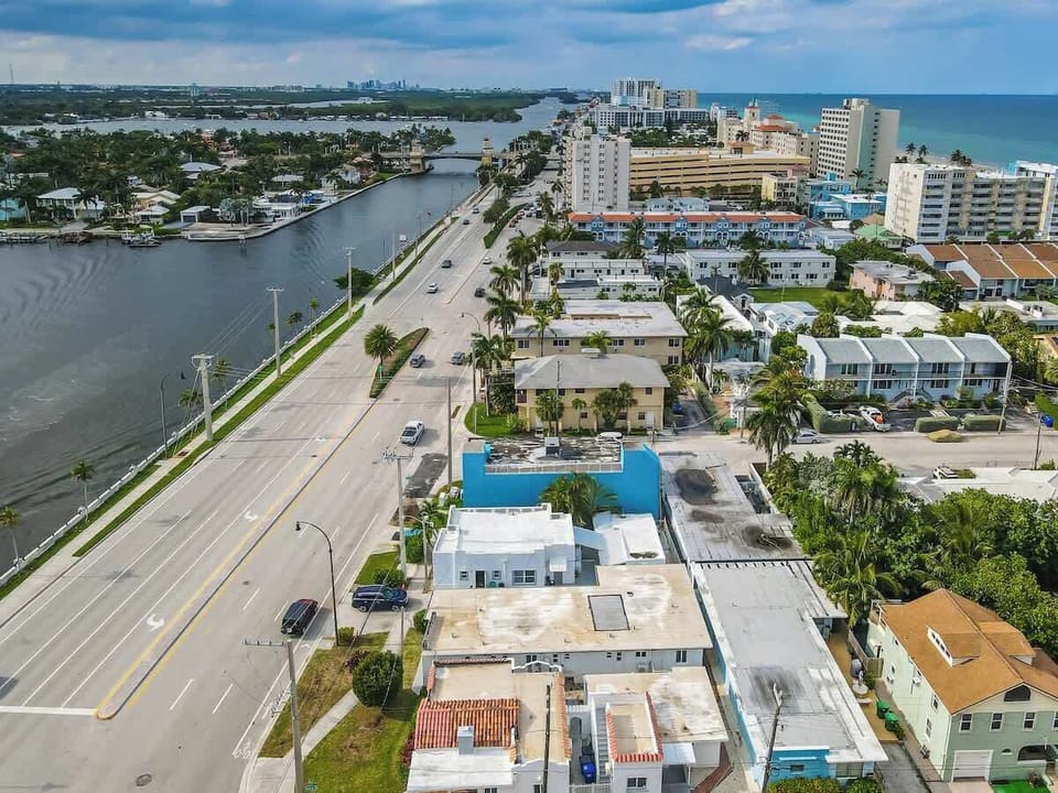 Coastal cityscape with ocean views and palm-lined streets—your tropical Airbnb getaway starts here.