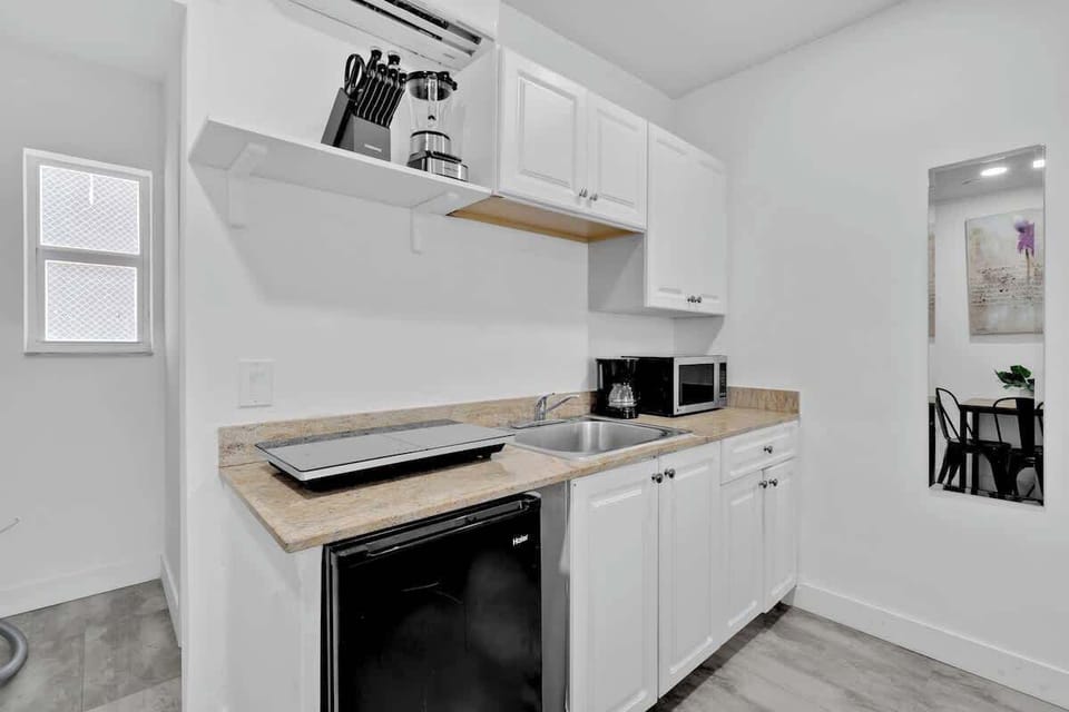 Compact kitchen with modern appliances and cozy dining area—ideal for guests who love cooking while traveling.